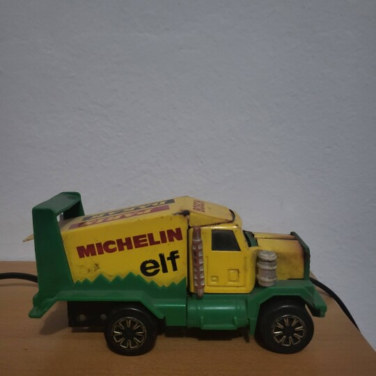 Image of Vintage green toy Truck with famous brand logos