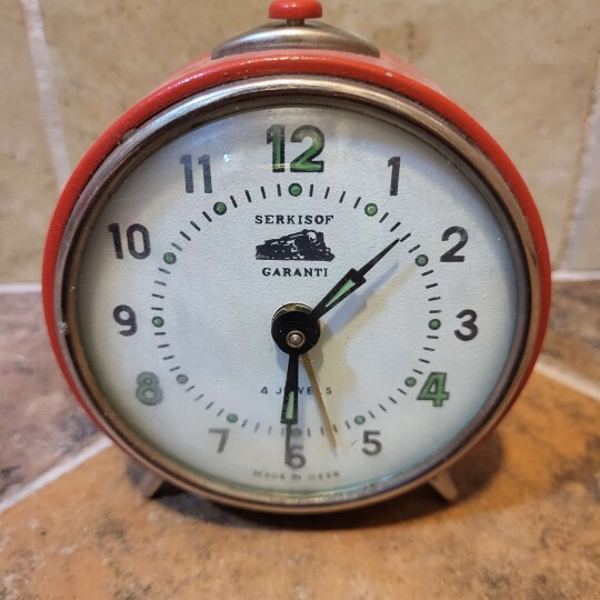 Image of Vintage desk alarm clock Serkisof, mechanical, USSR (Soviet), 1970s. Working Vintage clock. Old alarm clock.